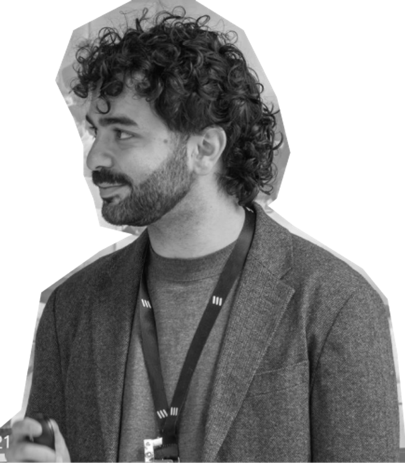 Nikos in side profile, wearing an Ericsson lanyard.