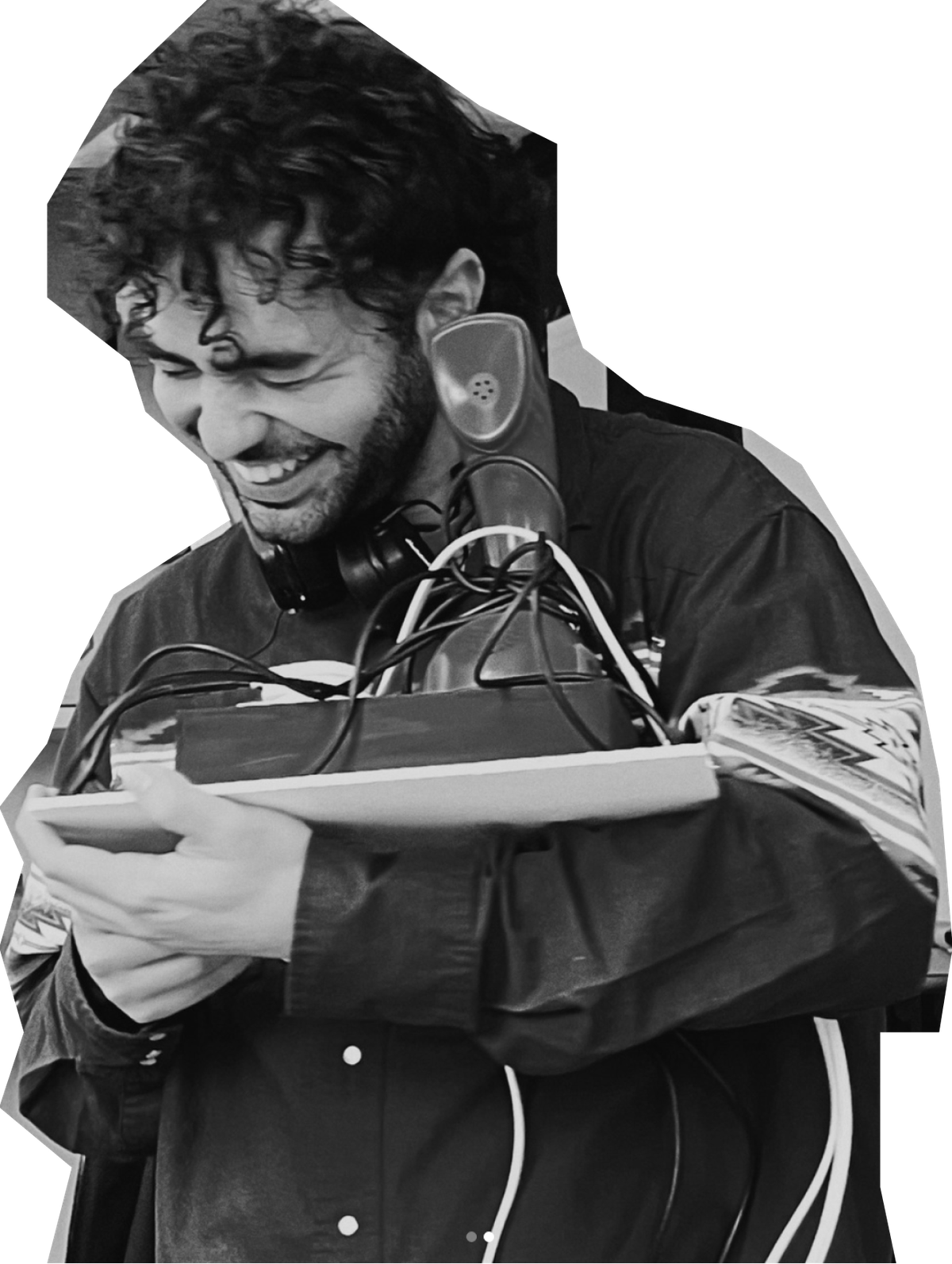 Nikos laughing while holding an Ericofon rotary phone, the same model at the centre of his Don't Be a Stranger installation.