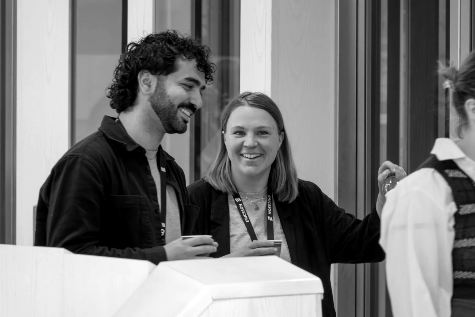 Nikos and Frida Edstam laughing together over coffee at the conference.