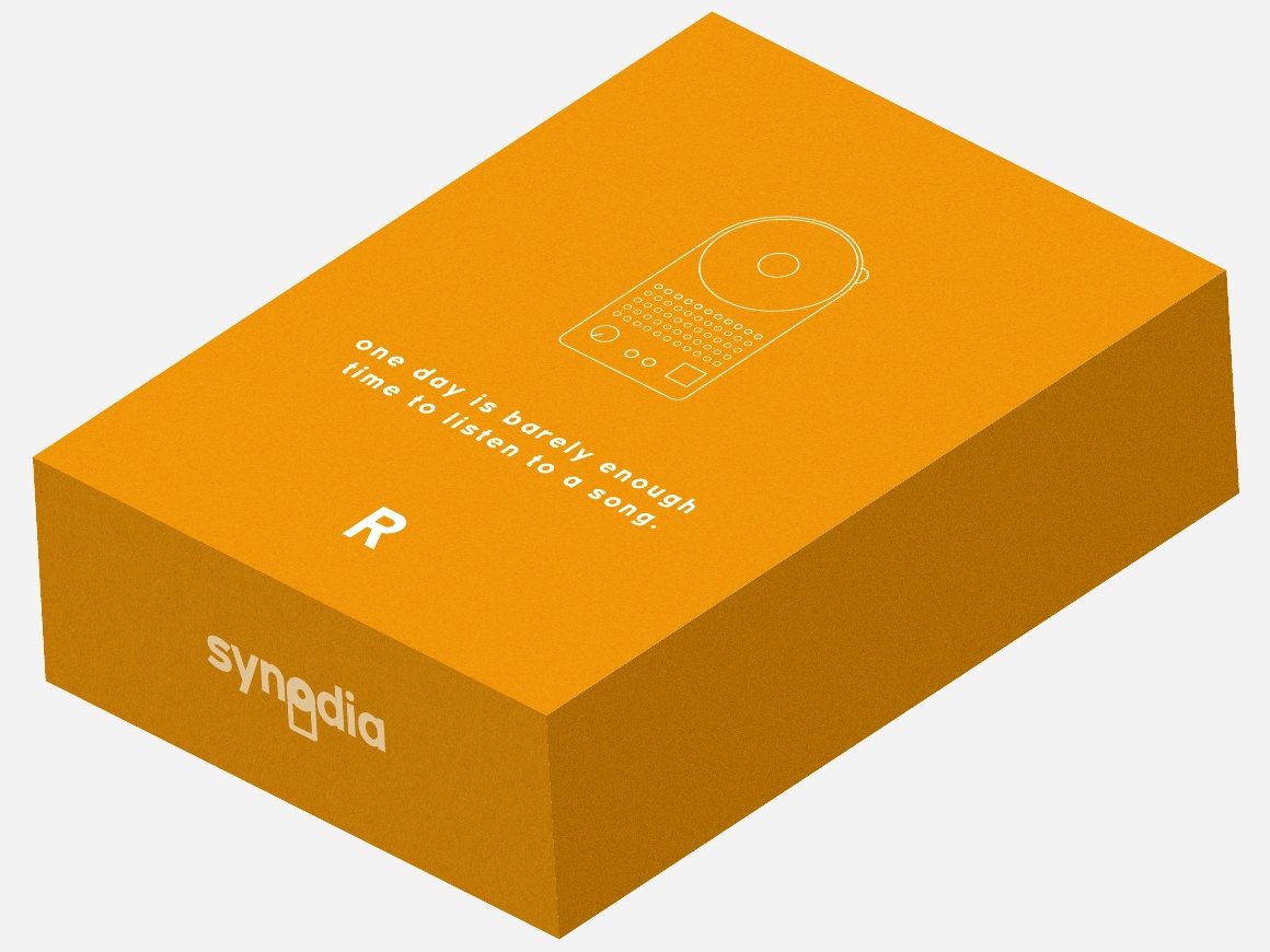 An orange Synodia box with a line drawing of the device, an R for the right-handed version, and the words 'one day is barely enough time to listen to a song'.
