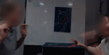 Two students pulling back in surprise as the table responds.